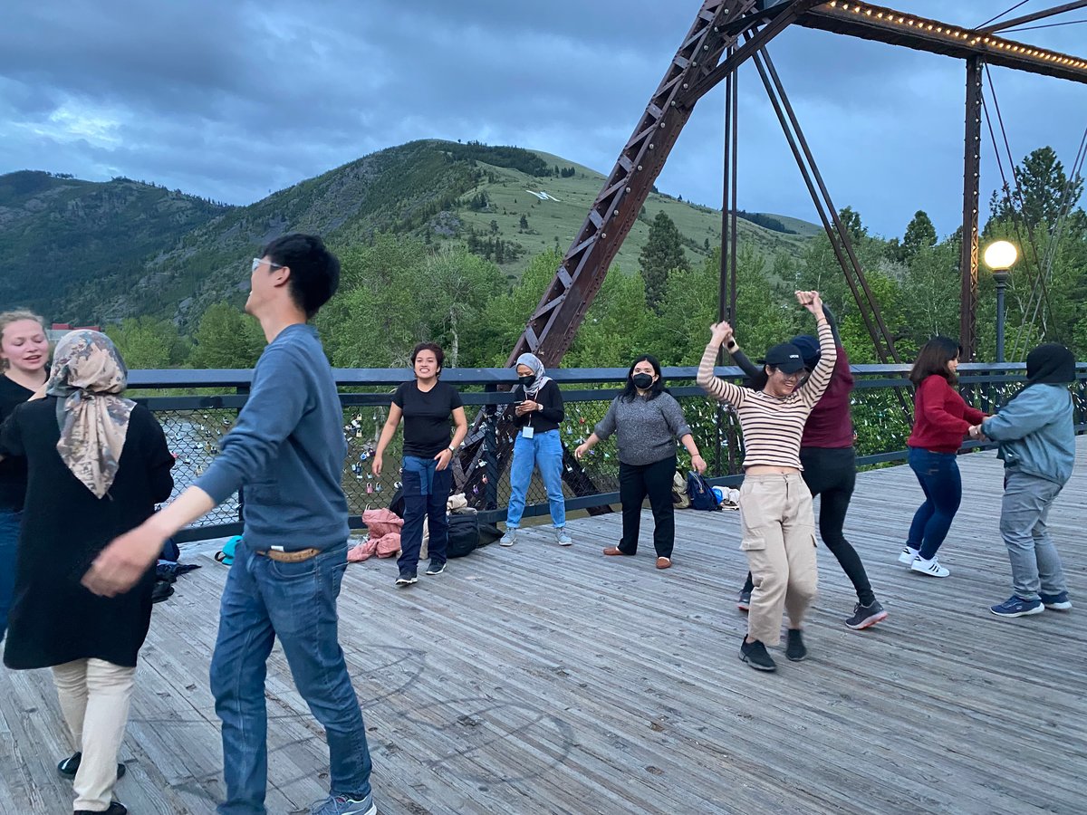 A group of fellows on a bridge over the Clark Fork river in Missoula